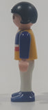 1995 Geobra Playmobil Small Black Haired Girl Child White Pants Blue Sweater with Yellow Red White Stripes 1/8" Tall Toy Figure