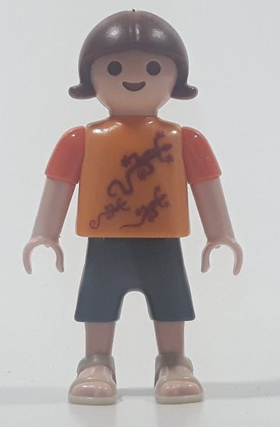 2010 Geobra Playmobil Small Brunette Girl Child Dark Grey Capri Pants Two Tone Orange Shirt with Lizard Design 2 1/8" Tall Toy Figure