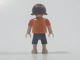 2010 Geobra Playmobil Small Brunette Girl Child Dark Grey Capri Pants Two Tone Orange Shirt with Lizard Design 2 1/8" Tall Toy Figure