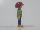 1995 Geobra Playmobil Small Brunette Boy Child Blue Pants Orange and Blue Striped Green Shirt Red Cap 2 1/8" Tall Toy Figure