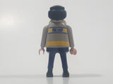 1997 Geobra Playmobil Black Hair Blue and Grey Firefighter 2 3/4" Tall Toy Figure