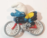 Vintage 1979 Peyo Smurfs Smurf Riding Bicycle 2 5/8" Long PVC Toy Figure