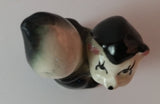 Vintage Girl Eye Lashed Skunk with Pink Bow Figurine Looking Upwards - Treasure Valley Antiques & Collectibles