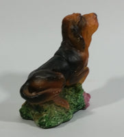 Vintage 1981 Dark Brown Hound Dog Holding Down a Pink Teddy Bear on Grass Collectible Figurine Numbered #714