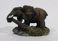 Elephant with Tusks Pulling a Log With It's Trunk Resin Figurine - SABRE - Treasure Valley Antiques & Collectibles