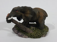 Elephant with Tusks Pulling a Log With It's Trunk Resin Figurine - SABRE - Treasure Valley Antiques & Collectibles