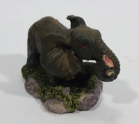 Elephant with Tusks Pulling a Log With It's Trunk Resin Figurine - SABRE - Treasure Valley Antiques & Collectibles
