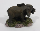 Elephant with Tusks Pulling a Log With It's Trunk Resin Figurine - SABRE - Treasure Valley Antiques & Collectibles