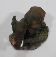 Elephant with Tusks Pulling a Log With It's Trunk Resin Figurine - SABRE - Treasure Valley Antiques & Collectibles
