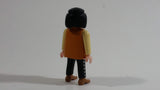1994 Geobra Playmobil Black Haired Pirate Man Black Bottoms Tan Orange Top White Sleeves Stubble and Eye patch 3" Tall Toy Figure