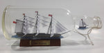 Vintage Highly Detailed HMS Surprise British Flagged Captured French Naval Tall Ship with Small Skiff Life Boat Sail Boat in 10 1/4" Long Glass Bottle