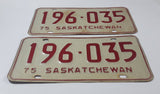 Set of Matching Vintage 1975 Saskatchewan Red Lettering White Vehicle License Plate Metal Tags 196 035