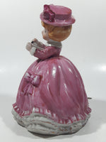Vintage Girl in Pink Dress with Bows Wearing a Hat Holding Pen and Paper 7" Ceramic Wind Up Musical Figurine