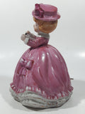 Vintage Girl in Pink Dress with Bows Wearing a Hat Holding Pen and Paper 7" Ceramic Wind Up Musical Figurine