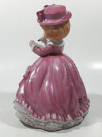 Vintage Girl in Pink Dress with Bows Wearing a Hat Holding Pen and Paper 7" Ceramic Wind Up Musical Figurine