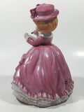 Vintage Girl in Pink Dress with Bows Wearing a Hat Holding Pen and Paper 7" Ceramic Wind Up Musical Figurine