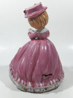 Vintage Girl in Pink Dress with Bows Wearing a Hat Holding Pen and Paper 7" Ceramic Wind Up Musical Figurine