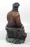 Captain on Rickety Boat Sitting In Busted Up Broken Life Raft Row Boat 9" Tall Weight Resin Figurine