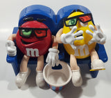 1999 M & M's Red And Yellow Character Sitting In Movie Theater Chairs Eating Popcorn Wearing 3D Glasses Plastic Candy Dispenser Machine