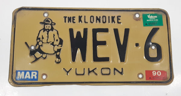 1989 1990 Yukon The Klondike Man Panning Gold Themed Yellow Metal Vehicle License Plate Tag WEV 6