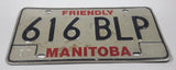 1983 Friendly Manitoba White With Black and Red Letters Metal Vehicle License Plate Tag 616 BLP